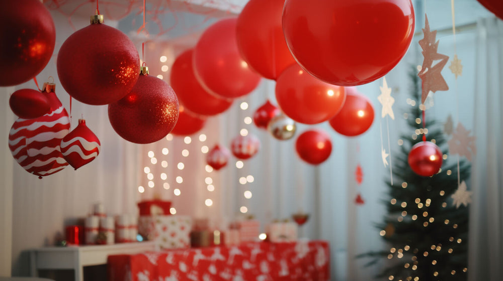 Festive red and white ornaments hanging over a table setup for creative Christmas party themes.