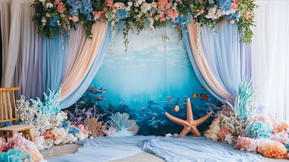 Underwater-themed backdrop and drapes for a mermaid birthday party setup