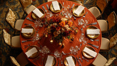 Overhead view of elegant fall-inspired table decor featuring golden accents, rich floral centerpieces.