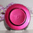Acrylic hot pink round charger plates with a beaded rim design, measuring 13 inches and 9 inches