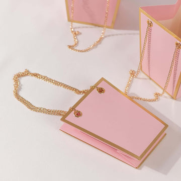 <span style="background-color:transparent;color:#000000;">Pink Gold Paper Bags With Metal Chain Handles: A Touch Of Luxury With Practicality</span>