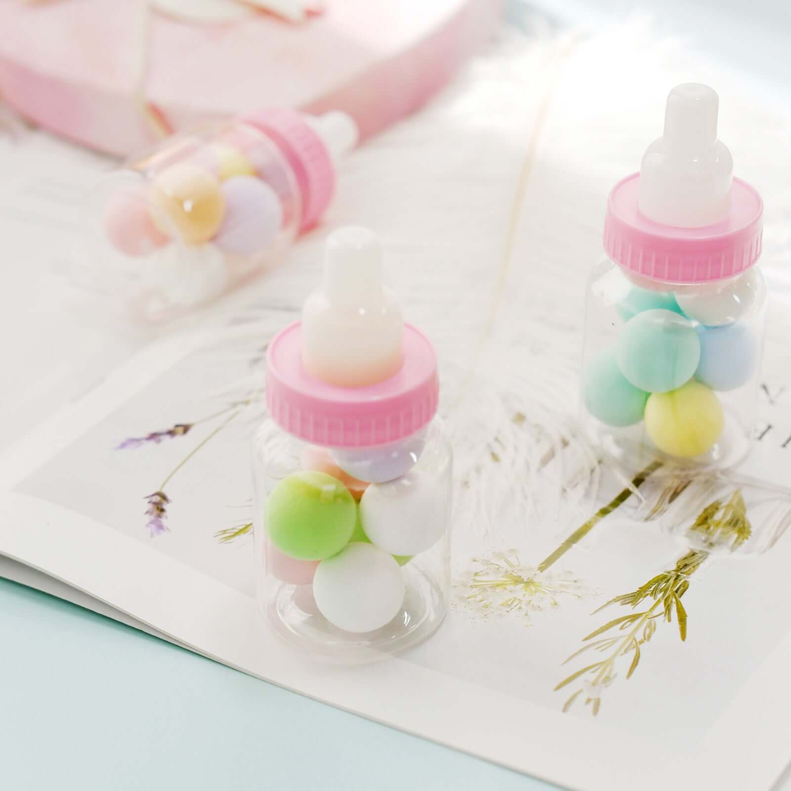 https://www.efavormart.com/cdn/shop/products/Clear-Pink-Baby-Bottle-Candy-Treat-Gift-Boxes.jpg?v=1689407023