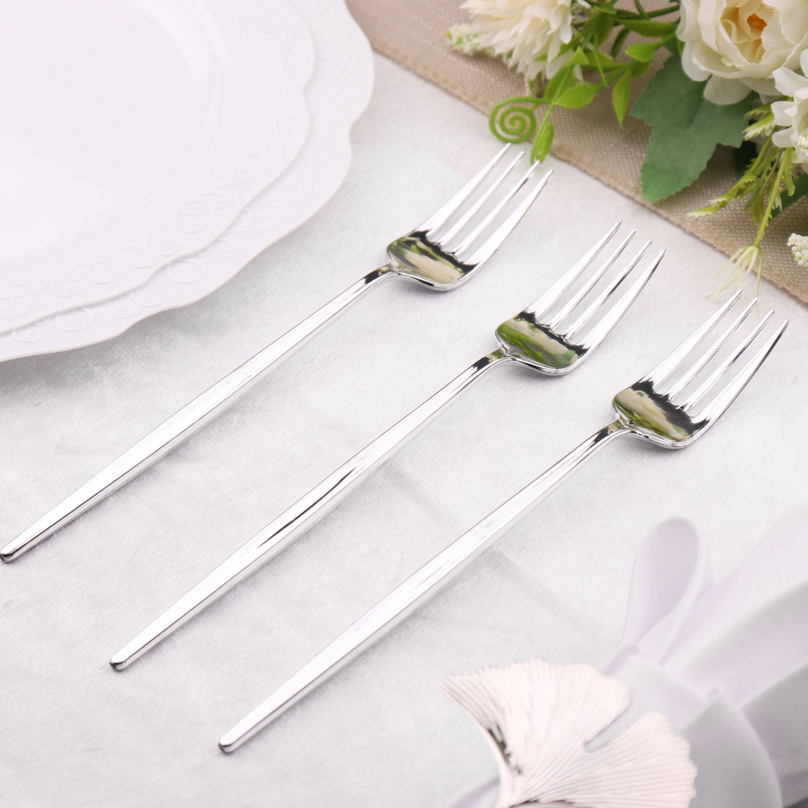 https://www.efavormart.com/cdn/shop/products/Glossy-Silver-Heavy-Duty-Plastic-Silverware-Forks.jpg?v=1689407583